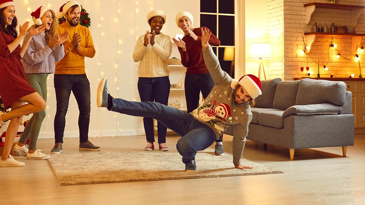 Article Cards Featured Image Group of happy young diverse people dancing and having fun at Christmas party at home