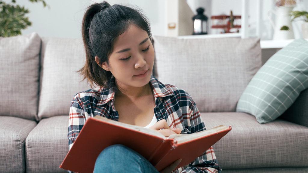 Anxiety after loss with a woman writing in a journal.