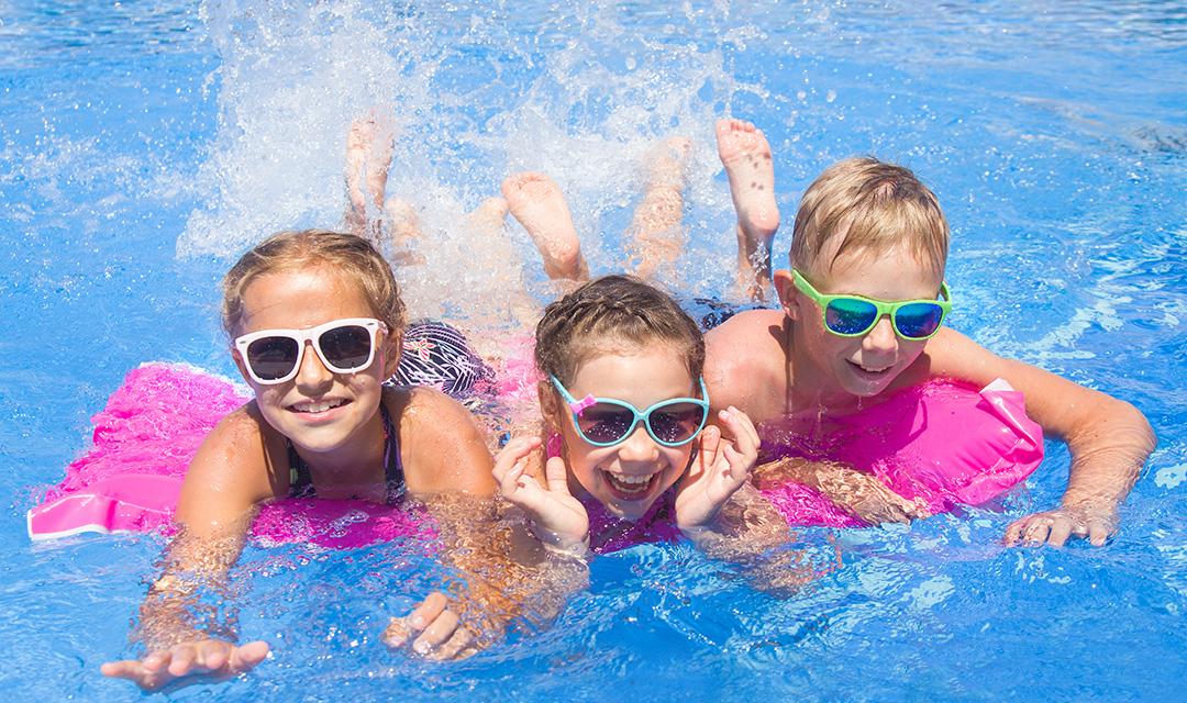 summer birthday with kids swimming in a pool