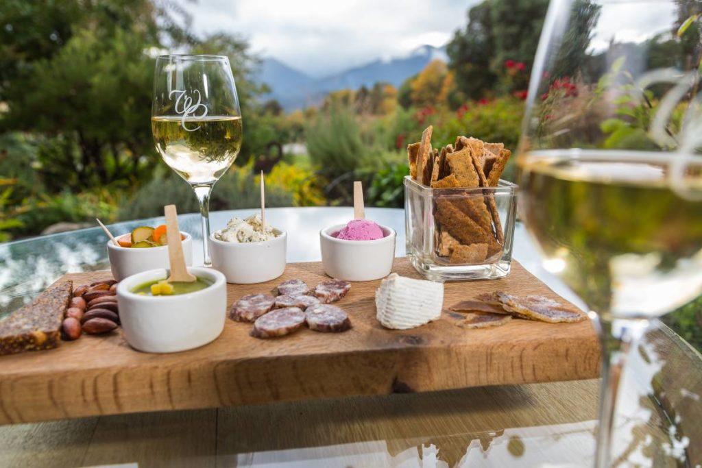 Father's Day trips with a charcuterie board with two glasses of wine outside on a table.