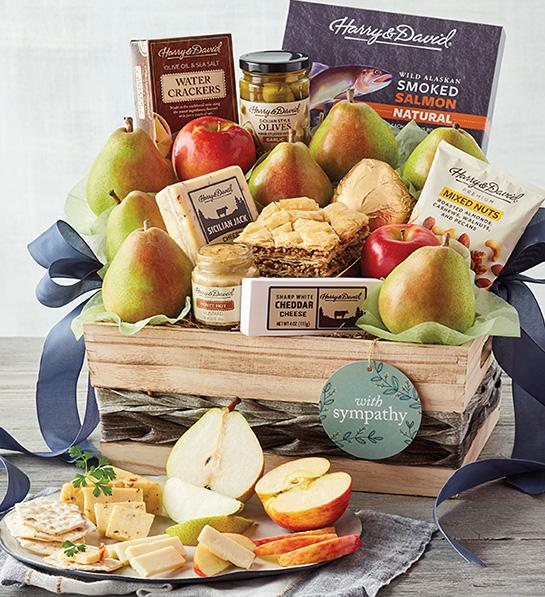 Sympathy gift ideas image   Harry & David Grand Sympathy Gift Basket with sliced cheese, pear, apple and crackers displayed in front.