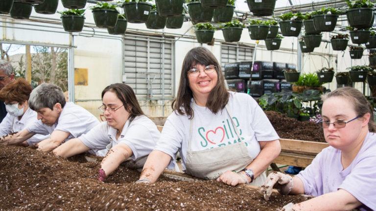 Smile farms image   group of farmers sifting dirt