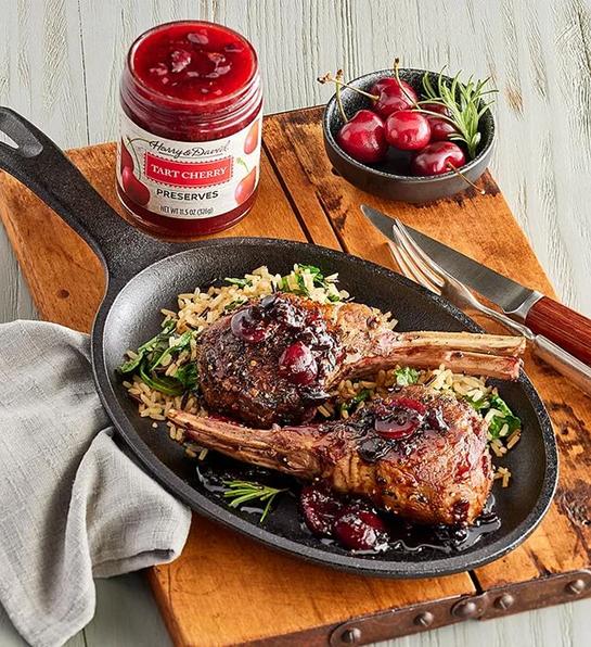 Lamb with cherry glaze in a cast iron skillet.